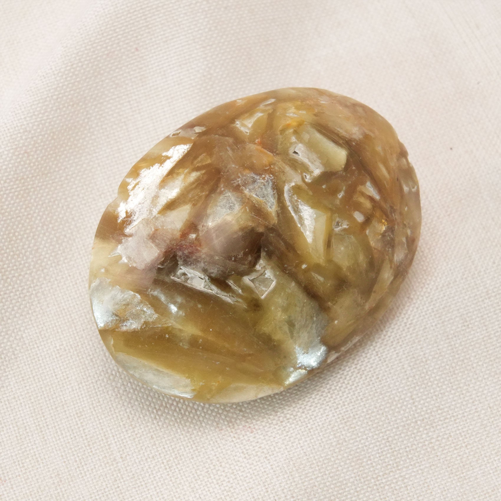 Golden Lepidolite Palm Stone supports overall well-being and enhances physical vitality