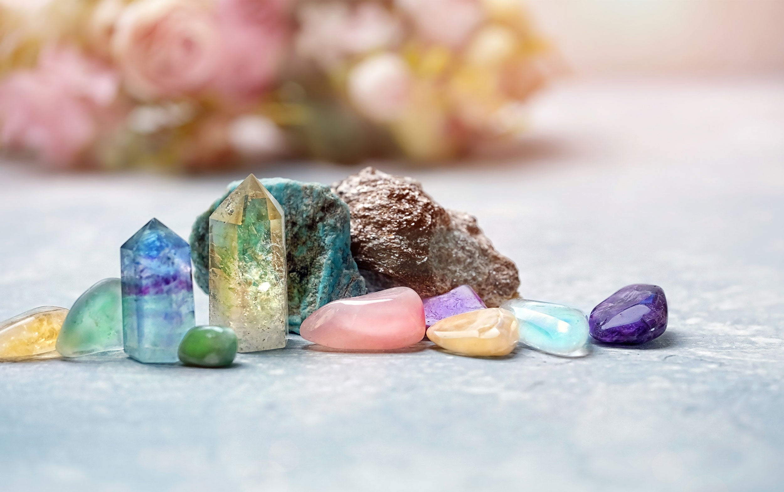 A vibrant Aura Quartz crystal with iridescent rainbow colors and a glossy