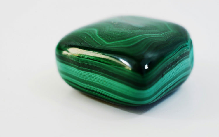 malachite stone displaying its unique green patterns and glossy surface