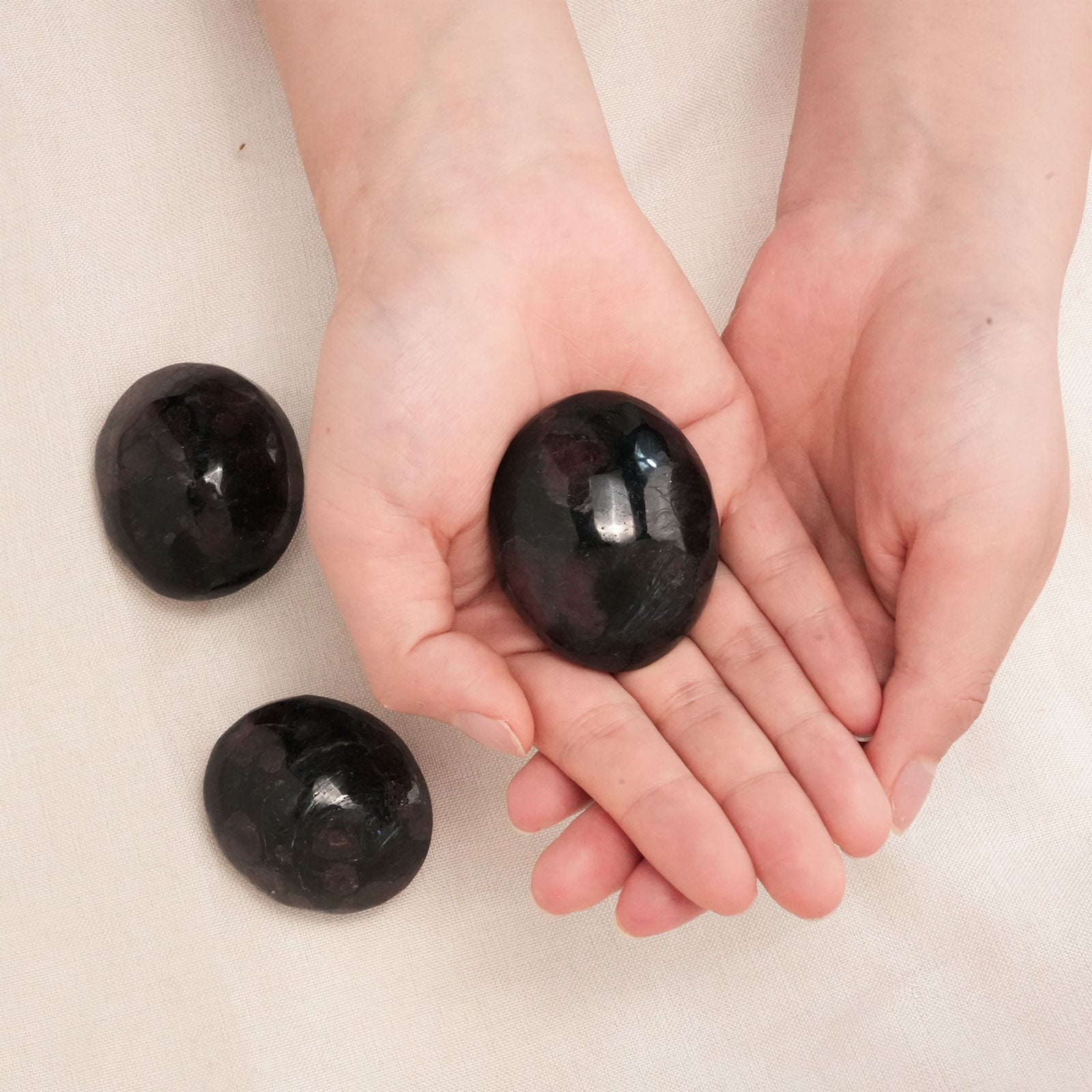 Polished Garnet Palm Stone promoting emotional balance and inner strength