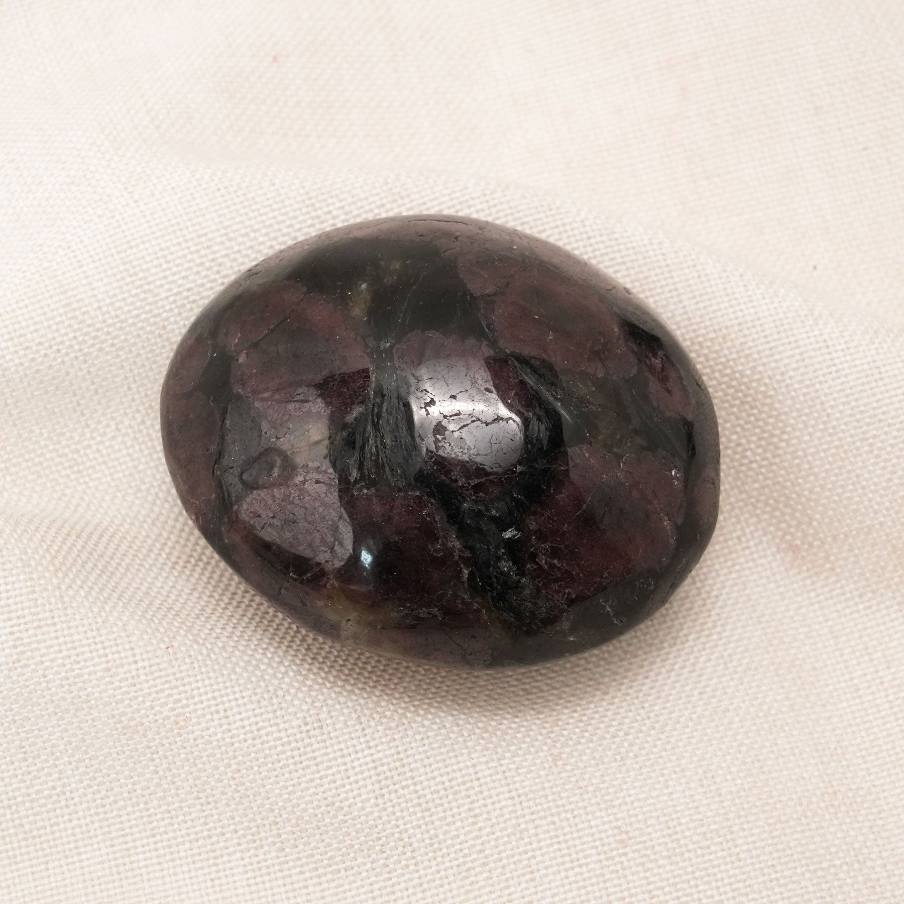 Garnet Palm Stone with deep red hues, perfect for boosting energy and vitality