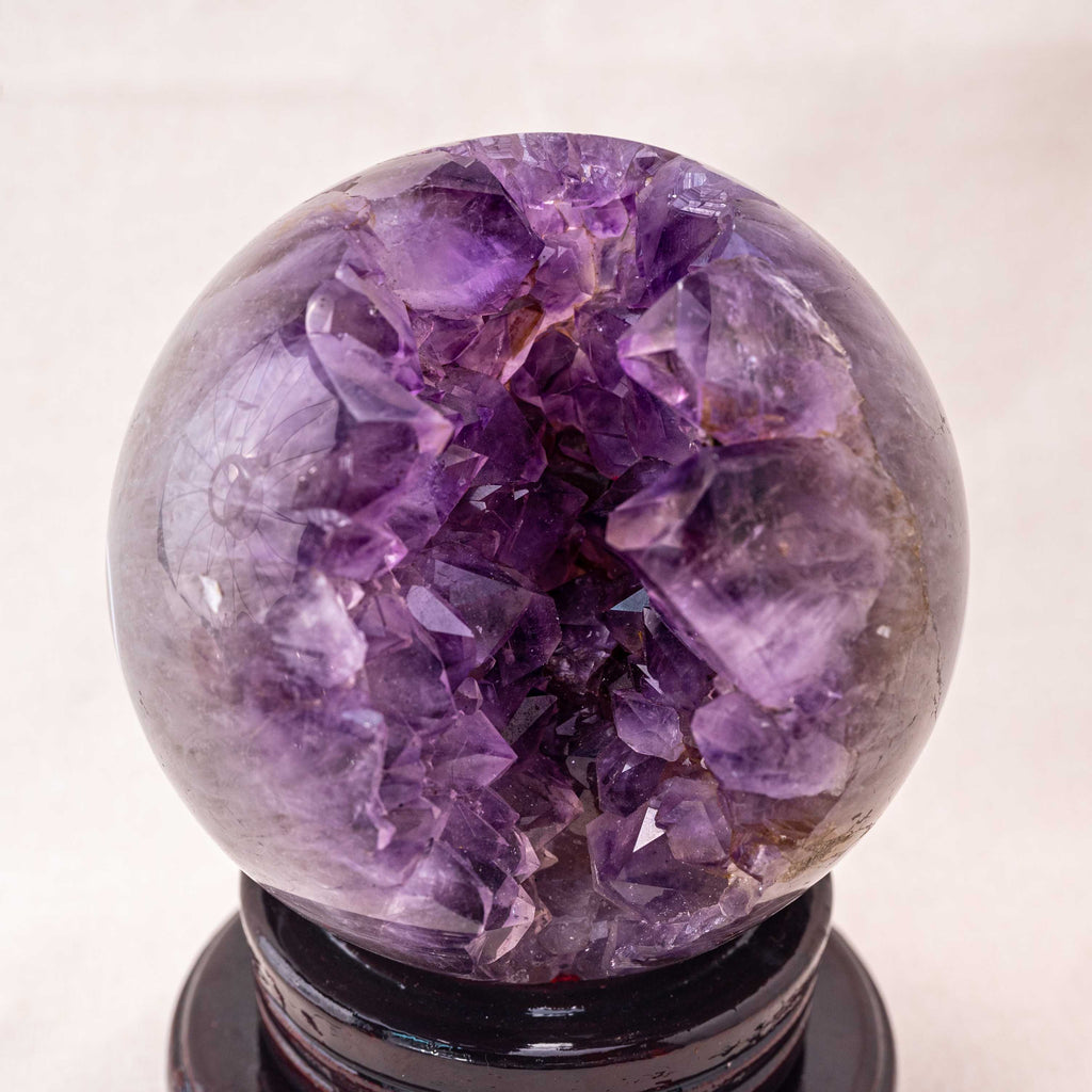 Amethyst crystal sphere with a natural cluster, ideal for spiritual healing