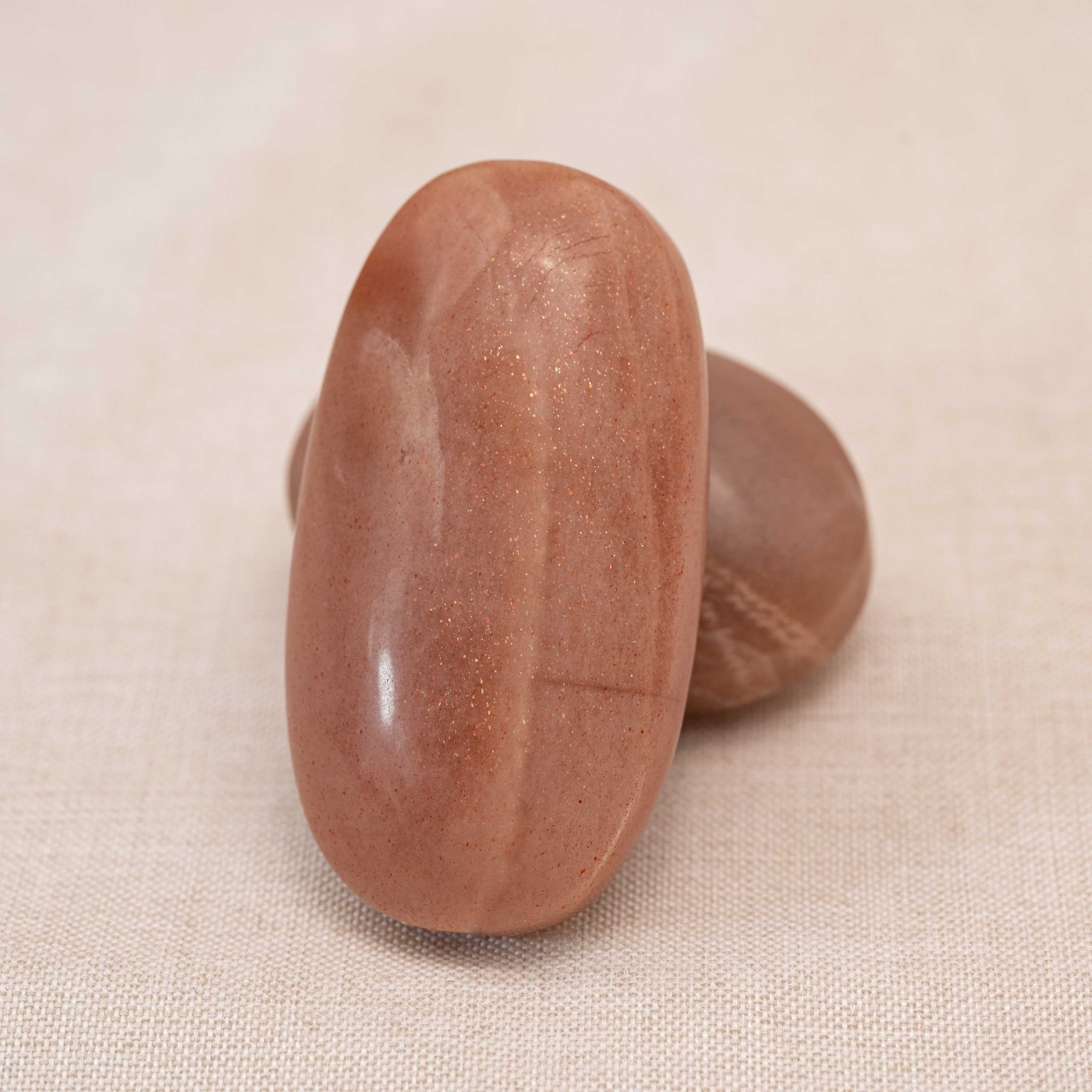 Golden Sun Stone Palm Stone with vibrant golden hues and natural patterns