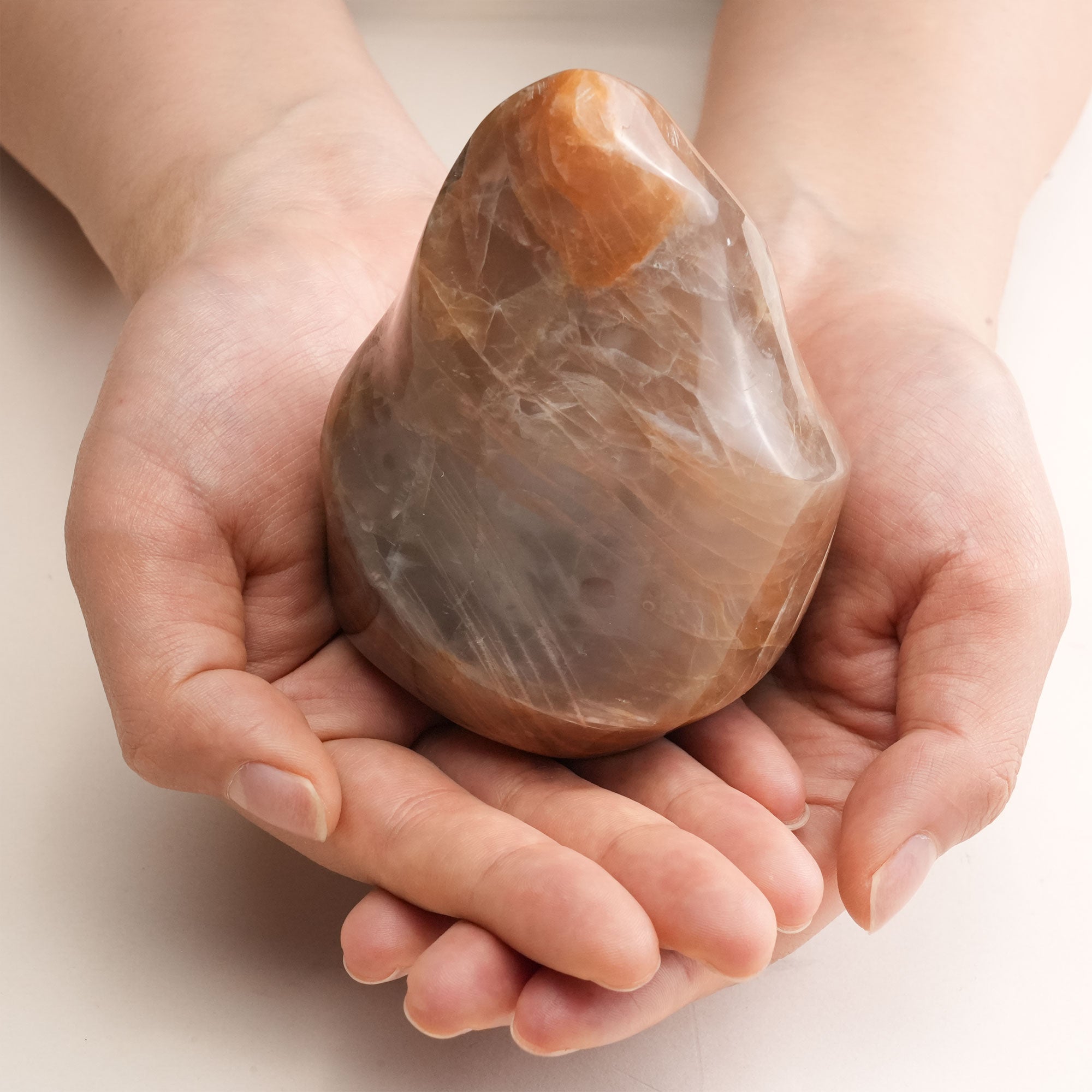 Orange Moonstone Flame Crystal in a serene setting, promoting emotional balance and creativity