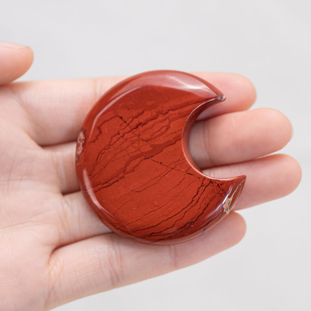 Hand holding Red Jasper Star/Moon Palm Stone